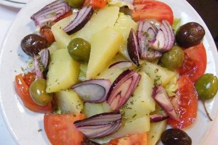 insalata vastasa, all ingredients -potato, tomato, onion and olives - straight from the greengrocer, mixed together and served; simple