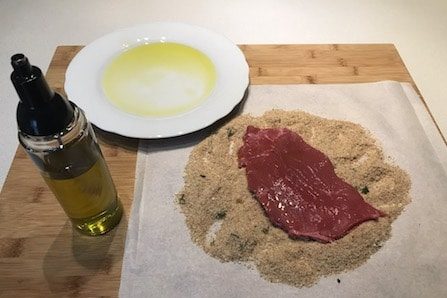 breading meat after a bath in olive oil